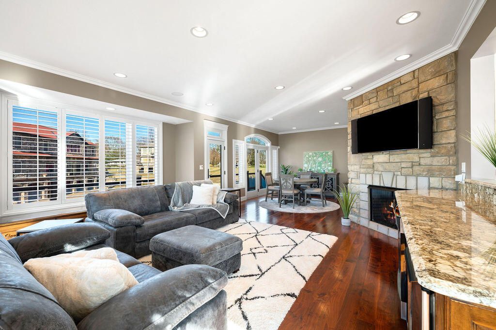 Dining room, Fireplace, Interior, Living room, Recessed Lighting, Stone Walls, Wood Texture Flooring