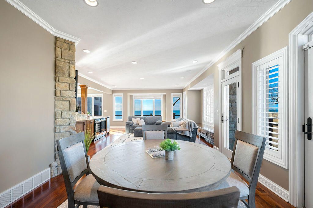 Dining room, Fireplace, Interior, Living room, Recessed Lighting, Stone Walls, Water, Wood Texture Flooring