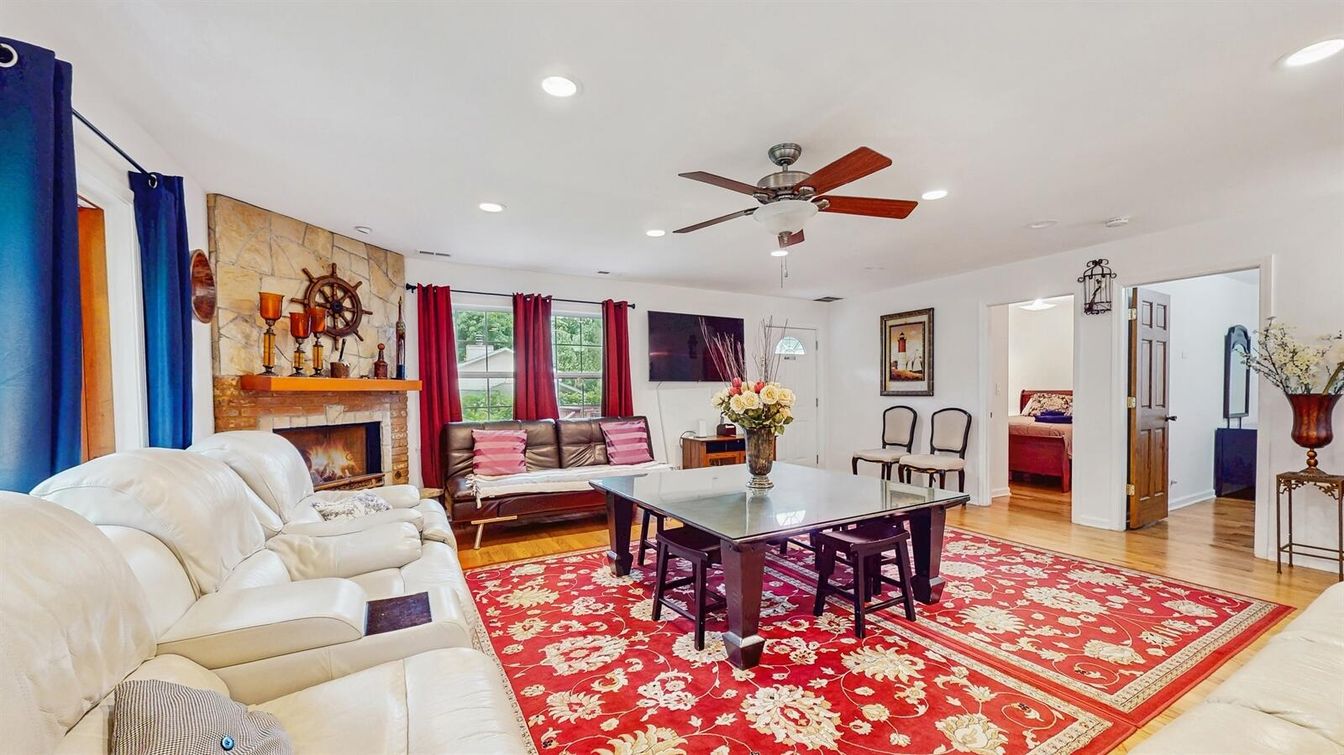 Dining room, Fireplace, Interior, Living room, Recessed Lighting, Stone Walls, Wood Texture Flooring