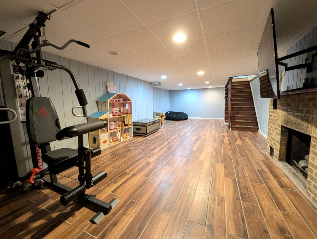 Fireplace, Fitness Equipment, Interior, Recessed Lighting, Wood Texture Flooring