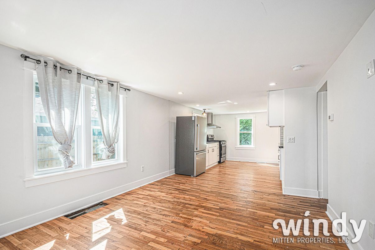 Empty room, Interior, Kitchen, Recessed Lighting, Stainless Steel Appliances, Wood Texture Flooring