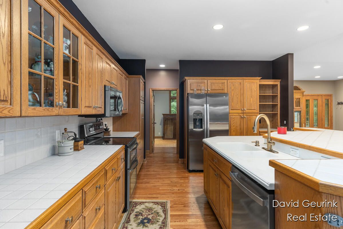 Interior, Kitchen, Recessed Lighting, Stainless Steel Appliances, Tile Countertops, Wood Texture Flooring
