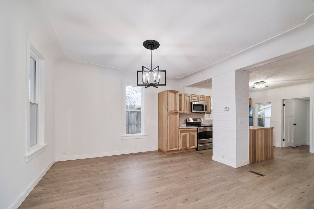 Empty room, Interior, Kitchen, Pendant Lights, Stainless Steel Appliances, Wood Texture Flooring