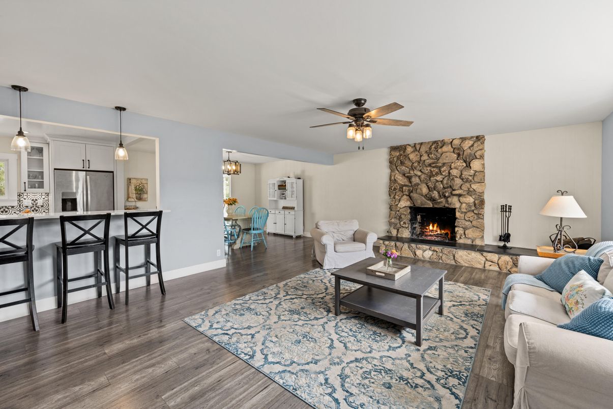 Dining room, Fireplace, Interior, Kitchen, Living room, Pendant Lights, Stainless Steel Appliances, Stone Walls, Wood Texture Flooring