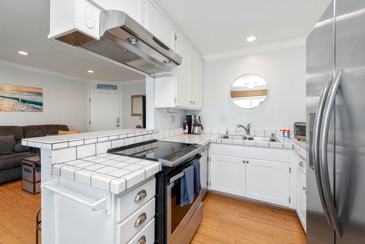 Interior, Kitchen, Recessed Lighting, Stainless Steel Appliances, Tile Countertops, Wood Texture Flooring