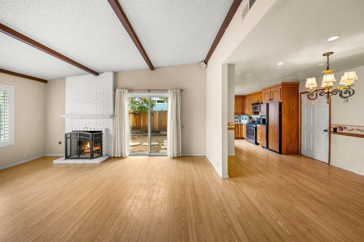 Chandelier, Empty room, Fireplace, Interior, Kitchen, Recessed Lighting, Stone Walls, Wooden Beams, Wood Texture Flooring