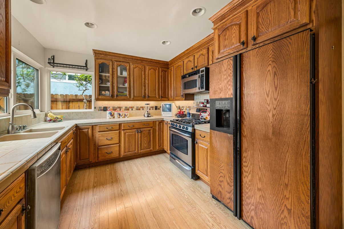 Interior, Kitchen, Recessed Lighting, Stainless Steel Appliances, Tile Countertops, Wood Texture Flooring