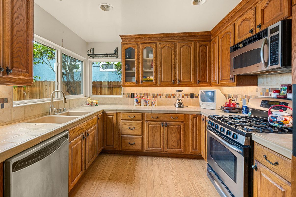 Interior, Kitchen, Recessed Lighting, Stainless Steel Appliances, Tile Countertops, Wood Texture Flooring