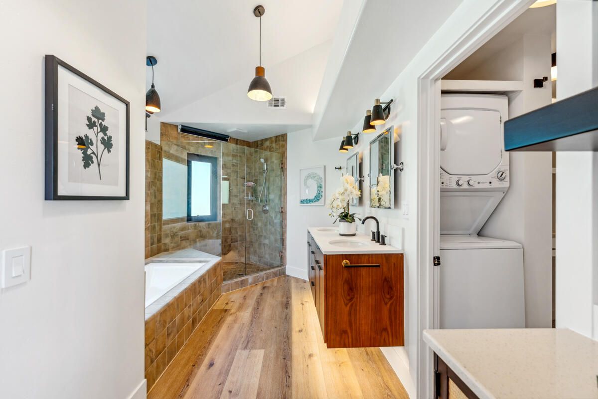 Bathroom, Dual Sink Vanities, Glass Shower, Interior, Pendant Lights, Stone Walls, Utility Closets, Washer, Wood Texture Flooring
