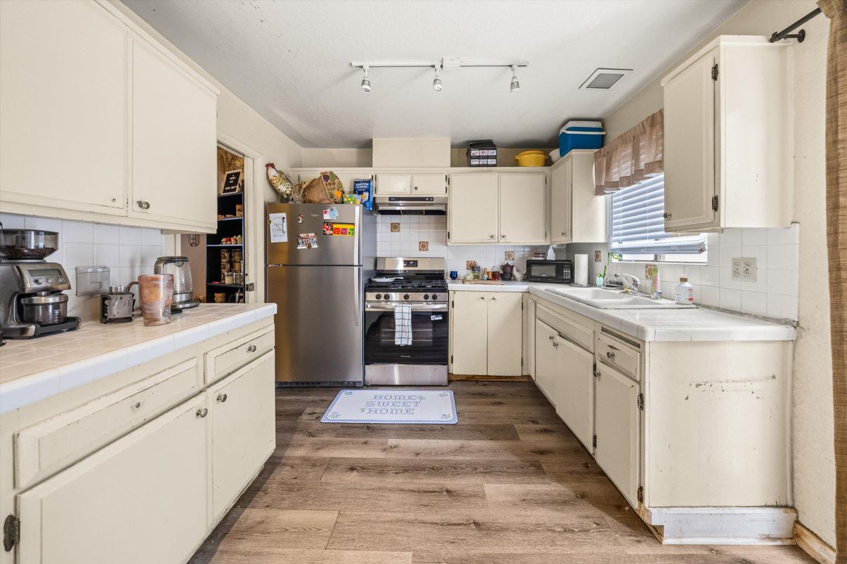 Interior, Kitchen, Stainless Steel Appliances, Tile Countertops, Wood Texture Flooring