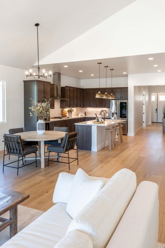 Chandelier, Dining room, Interior, Kitchen, Living room, Pendant Lights, Recessed Lighting, Stainless Steel Appliances, Wood Texture Flooring