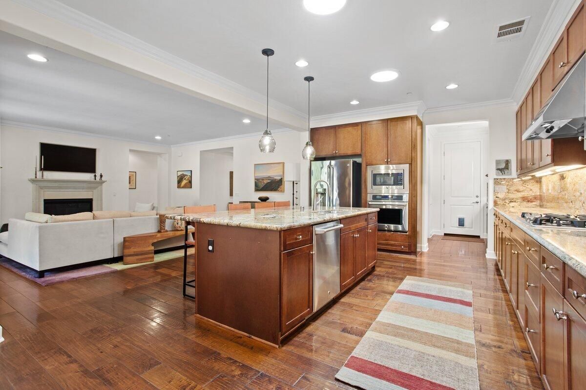 Fireplace, Interior, Kitchen, Living room, Pendant Lights, Recessed Lighting, Stainless Steel Appliances, Wood Texture Flooring