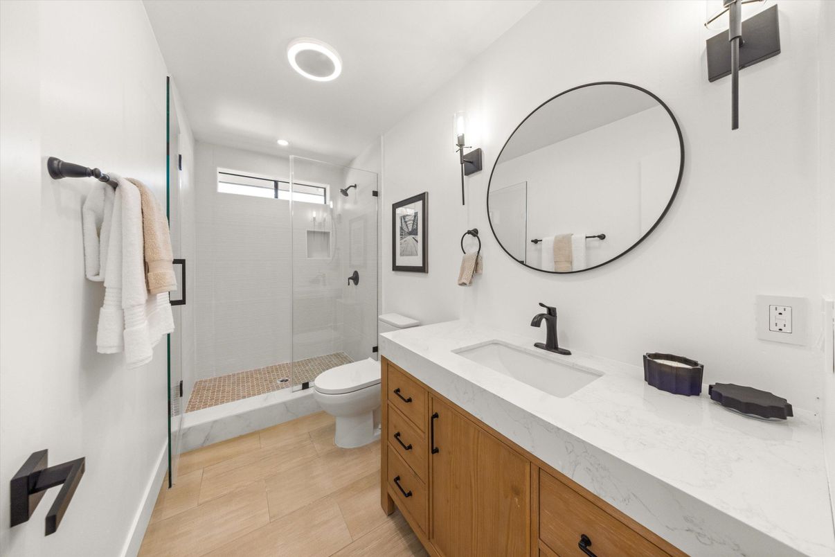 Bathroom, Dual Sink Vanities, Glass Shower, Interior, Recessed Lighting, Wood Texture Flooring