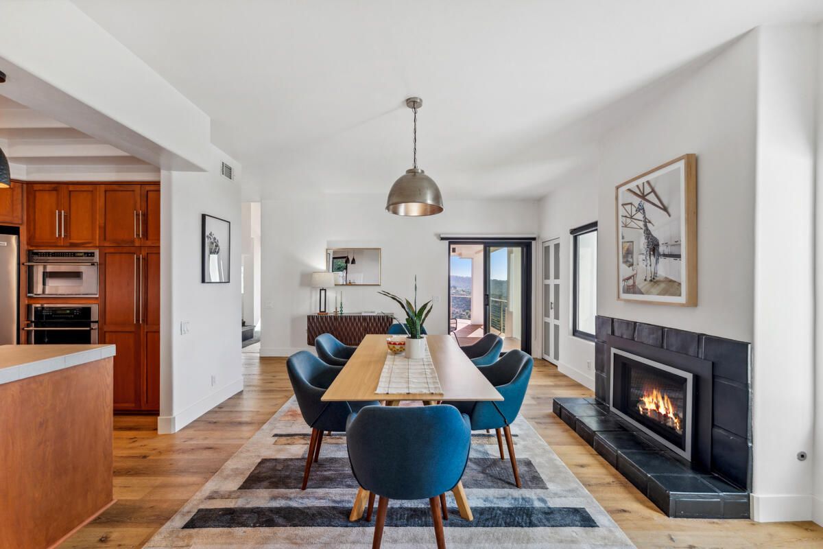 Dining room, Fireplace, Interior, Kitchen, Pendant Lights, Stainless Steel Appliances, Wood Texture Flooring