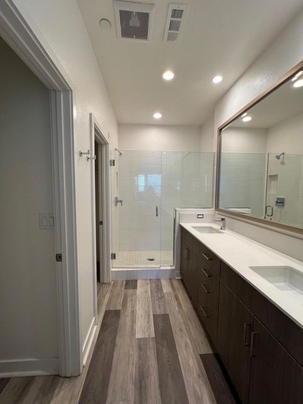 Bathroom, Dual Sink Vanities, Glass Shower, Interior, Recessed Lighting, Wood Texture Flooring