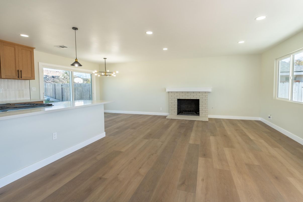Empty room, Fireplace, Interior, Kitchen, Pendant Lights, Recessed Lighting, Wood Texture Flooring