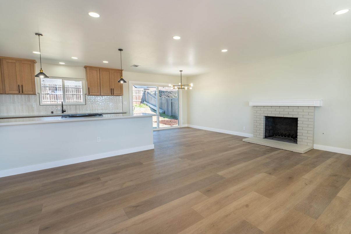 Empty room, Fireplace, Interior, Kitchen, Pendant Lights, Recessed Lighting, Wood Texture Flooring