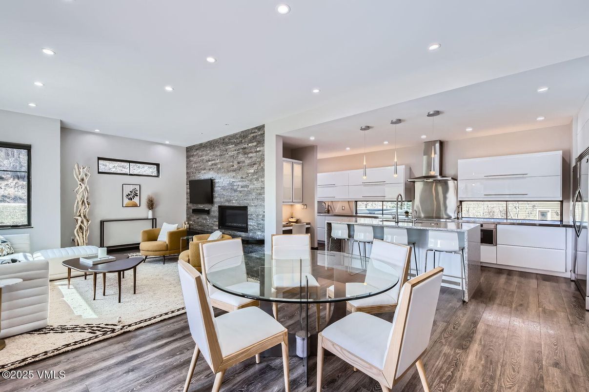 Dining room, Fireplace, Interior, Kitchen, Living room, Pendant Lights, Recessed Lighting, Stainless Steel Appliances, Stone Walls, Wood Texture Flooring