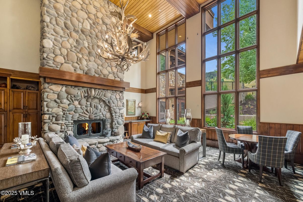 Chandelier, Dining room, Fireplace, Interior, Living room, Recessed Lighting, Stone Walls, Wooden Beams, Wooden Ceilings