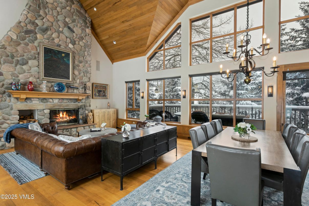 Chandelier, Dining room, Fireplace, Interior, Living room, Recessed Lighting, Stone Walls, Wooden Beams, Wooden Ceilings, Wood Texture Flooring