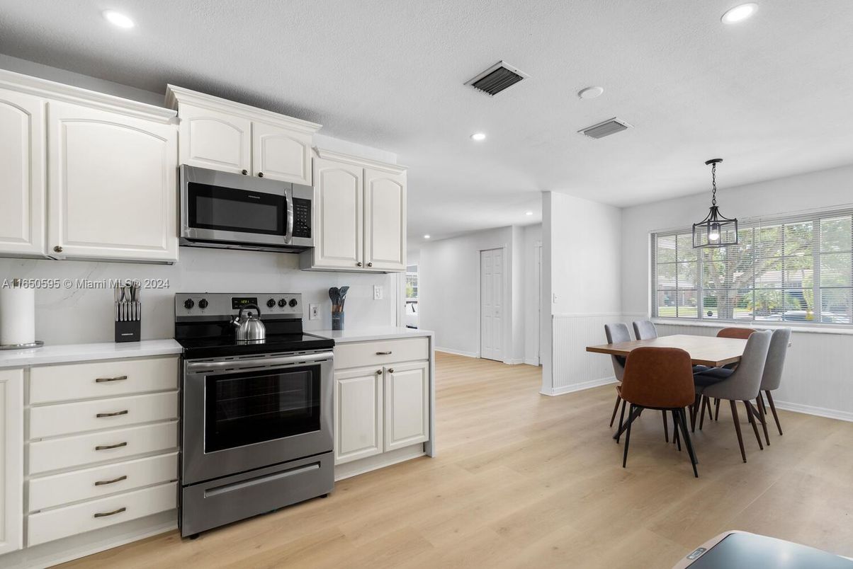 Dining room, Interior, Kitchen, Pendant Lights, Recessed Lighting, Stainless Steel Appliances, Wood Texture Flooring
