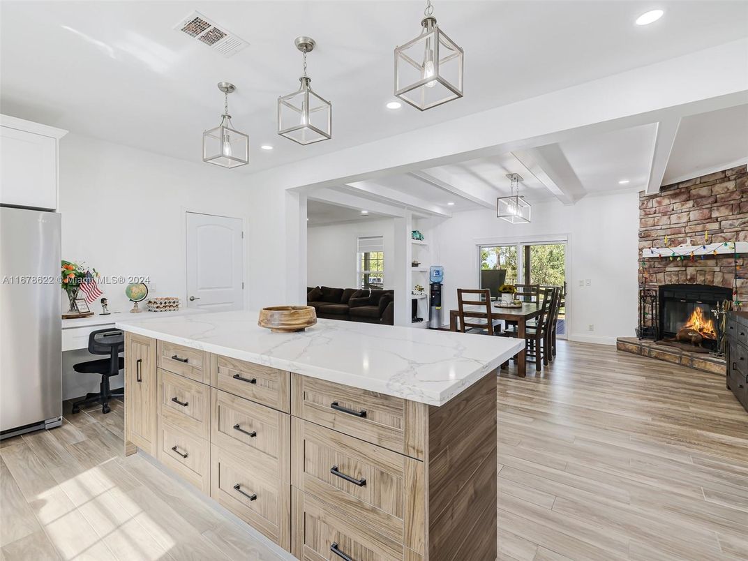 Dining room, Fireplace, Interior, Pendant Lights, Recessed Lighting, Stone Walls, Wood Texture Flooring