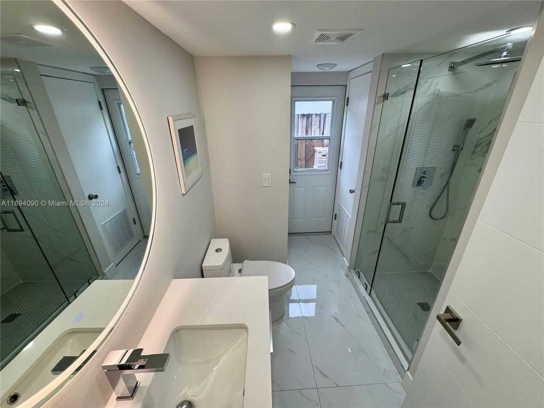 Bathroom, Dual Sink Vanities, Glass Shower, Interior, Marble, Marble Walls, Recessed Lighting