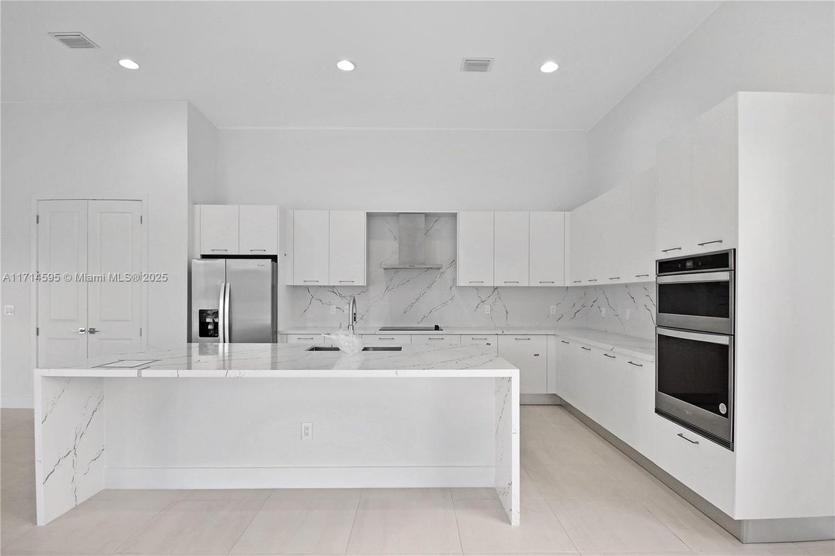 Interior, Kitchen, Marble Walls, Recessed Lighting, Stainless Steel Appliances