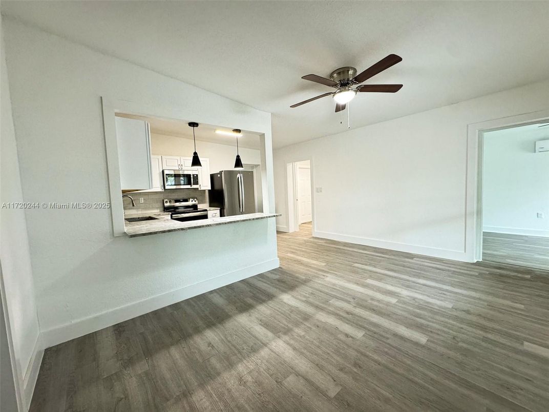Empty room, Interior, Kitchen, Pendant Lights, Stainless Steel Appliances, Wood Texture Flooring