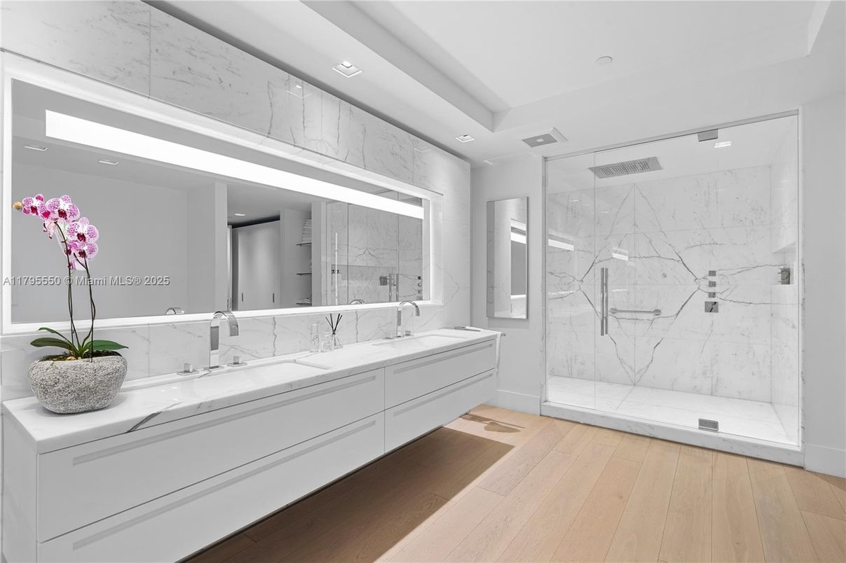 Bathroom, Dual Sink Vanities, Glass Shower, Interior, Marble Walls, Recessed Lighting, Wood Texture Flooring