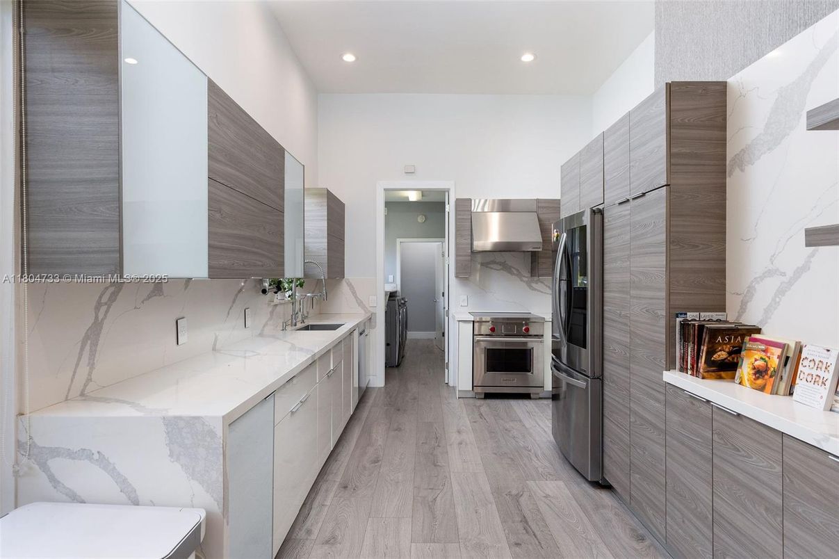 Interior, Kitchen, Marble Walls, Recessed Lighting, Stainless Steel Appliances, Wood Texture Flooring