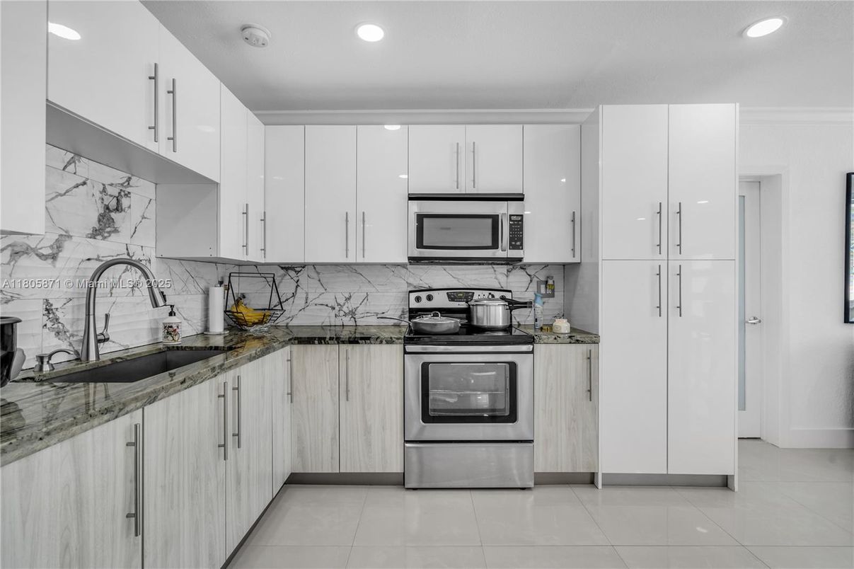 Interior, Kitchen, Marble Walls, Recessed Lighting, Stainless Steel Appliances
