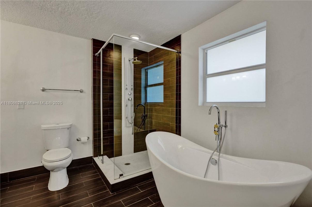 Bathroom, Free Standing Baths, Glass Shower, Interior, Recessed Lighting, Wood Texture Flooring