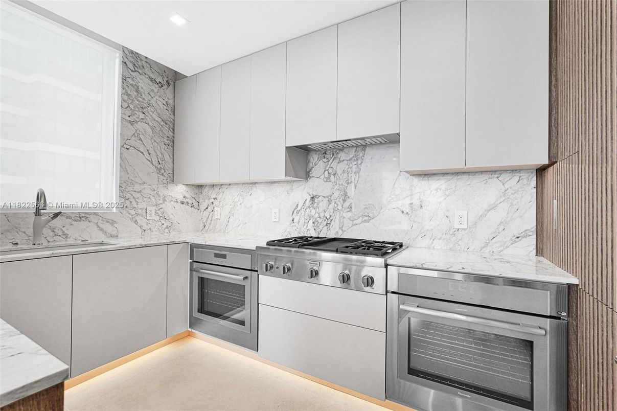 Interior, Kitchen, Marble Walls, Recessed Lighting, Stainless Steel Appliances