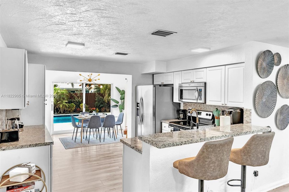 Dining room, Interior, Kitchen, Pendant Lights, Recessed Lighting, Stainless Steel Appliances, Wood Texture Flooring