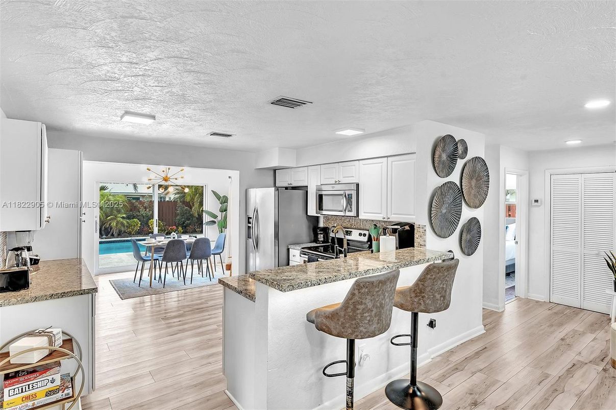 Dining room, Interior, Kitchen, Pendant Lights, Recessed Lighting, Stainless Steel Appliances, Wood Texture Flooring