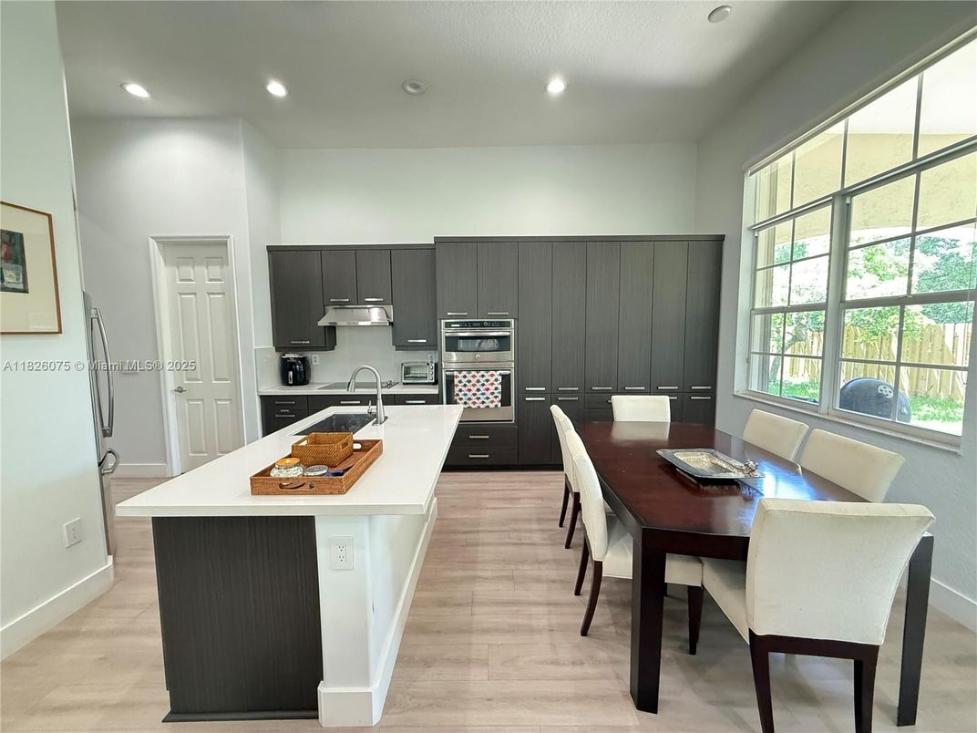 Dining room, Interior, Kitchen, Recessed Lighting, Stainless Steel Appliances, Wood Texture Flooring
