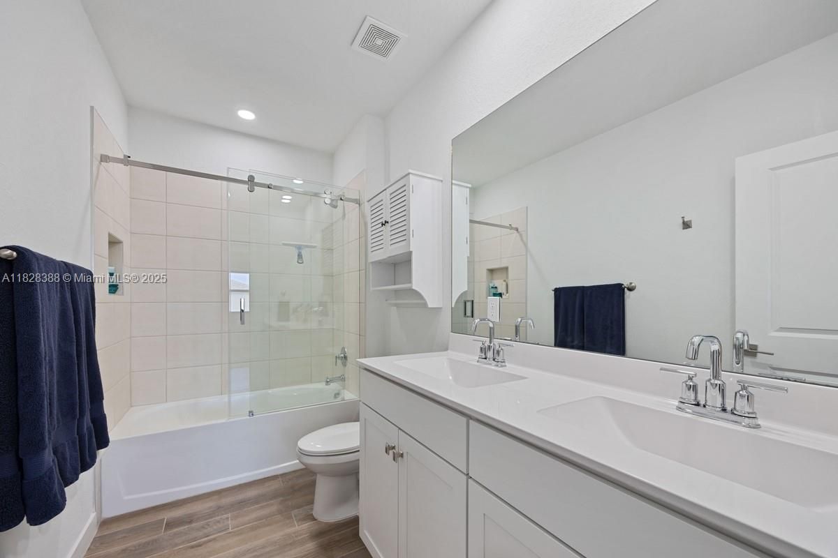Bathroom, Dual Sink Vanities, Glass Shower, Interior, Recessed Lighting, Wood Texture Flooring