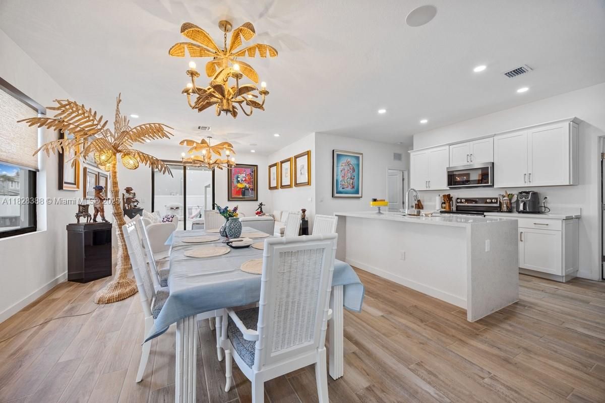 Chandelier, Dining room, Interior, Kitchen, Recessed Lighting, Stainless Steel Appliances, Wood Texture Flooring