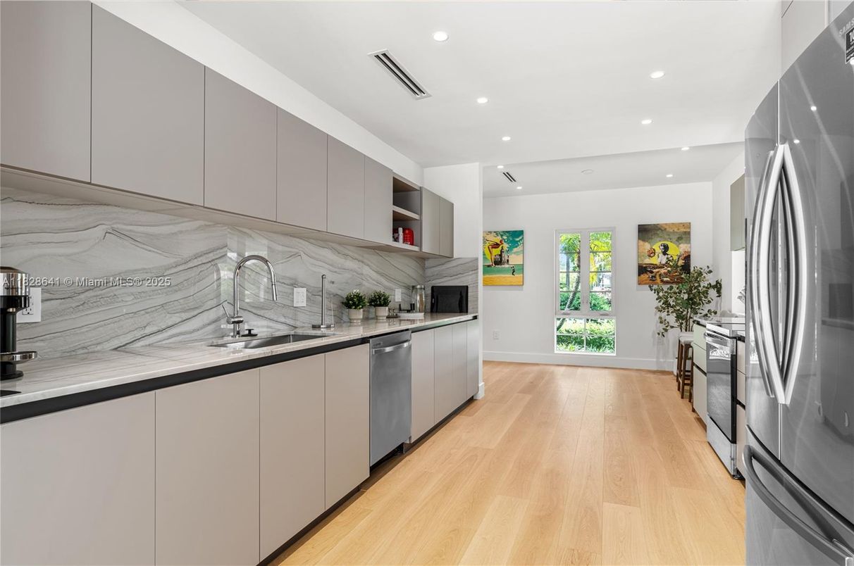 Interior, Kitchen, Marble Walls, Recessed Lighting, Stainless Steel Appliances, Wood Texture Flooring