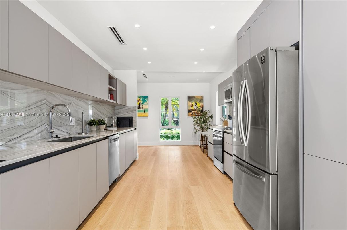 Interior, Kitchen, Marble Walls, Recessed Lighting, Stainless Steel Appliances, Wood Texture Flooring