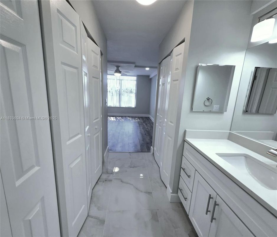 Bathroom, Dual Sink Vanities, Interior, Marble, Recessed Lighting, Wood Texture Flooring