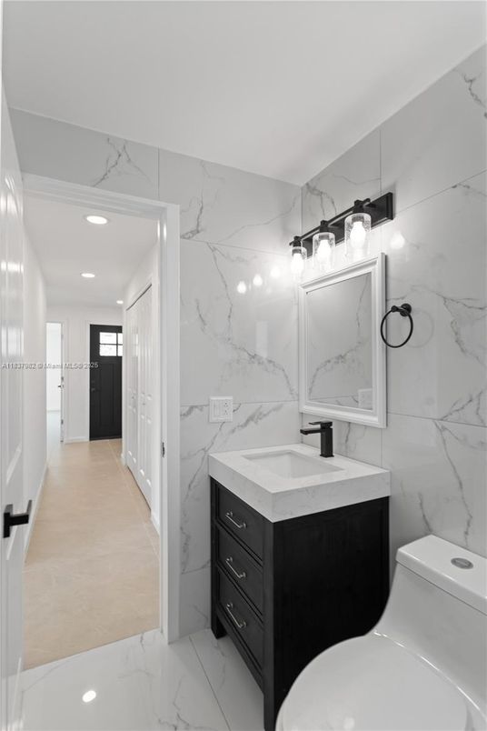 Bathroom, Dual Sink Vanities, Interior, Marble, Marble Walls, Recessed Lighting