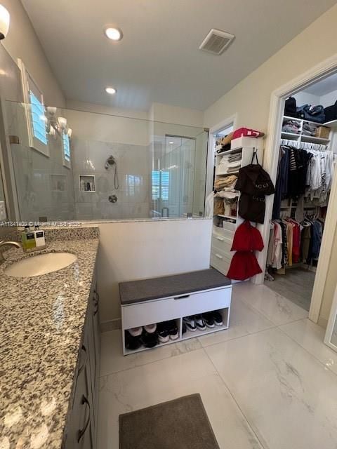 Bathroom, Dual Sink Vanities, Glass Shower, Interior, Marble, Recessed Lighting, Walk-in Closets