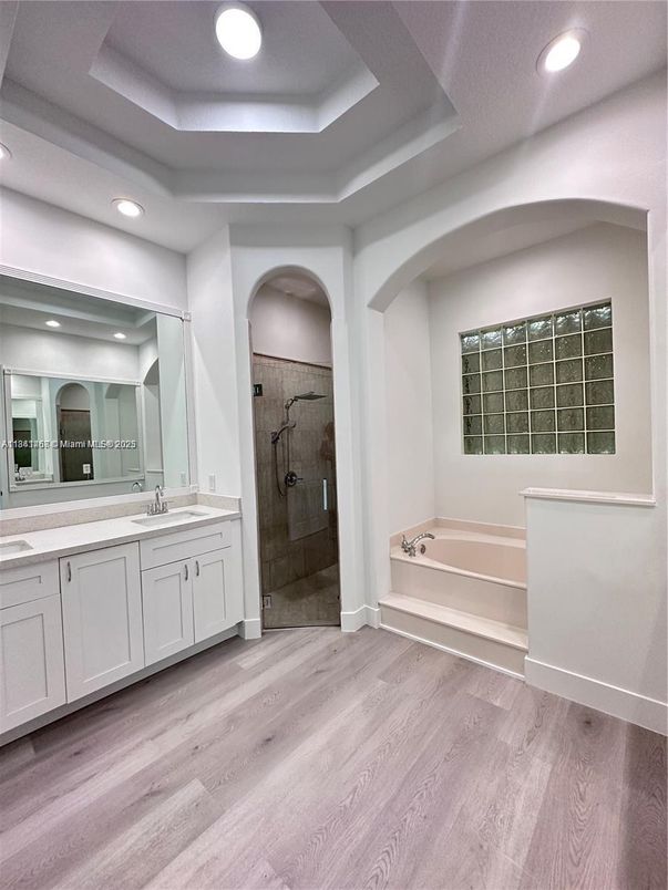 Bathroom, Dual Sink Vanities, Glass Shower, Interior, Recessed Lighting, Wood Texture Flooring