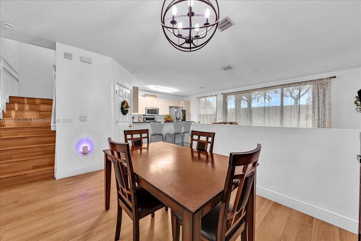 Chandelier, Dining room, Interior, Kitchen, Stainless Steel Appliances, Wood Texture Flooring