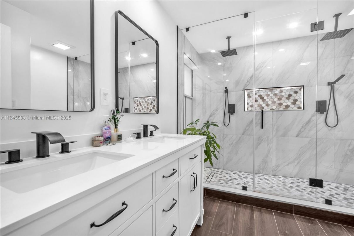 Bathroom, Dual Sink Vanities, Glass Shower, Interior, Marble Walls, Recessed Lighting, Wood Texture Flooring