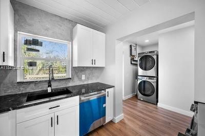 Interior, Kitchen, Recessed Lighting, Washer, Wood Texture Flooring