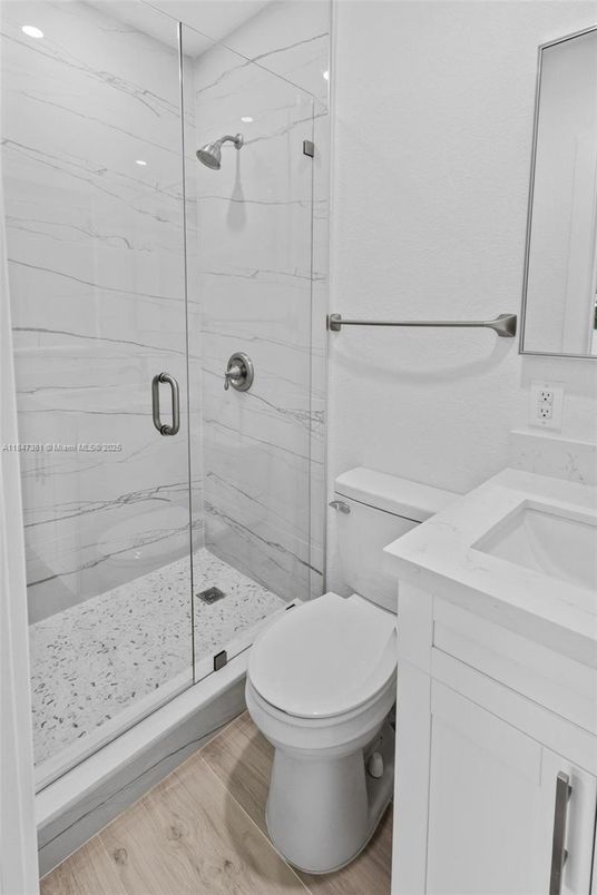 Bathroom, Glass Shower, Interior, Marble Walls, Recessed Lighting, Wood Texture Flooring