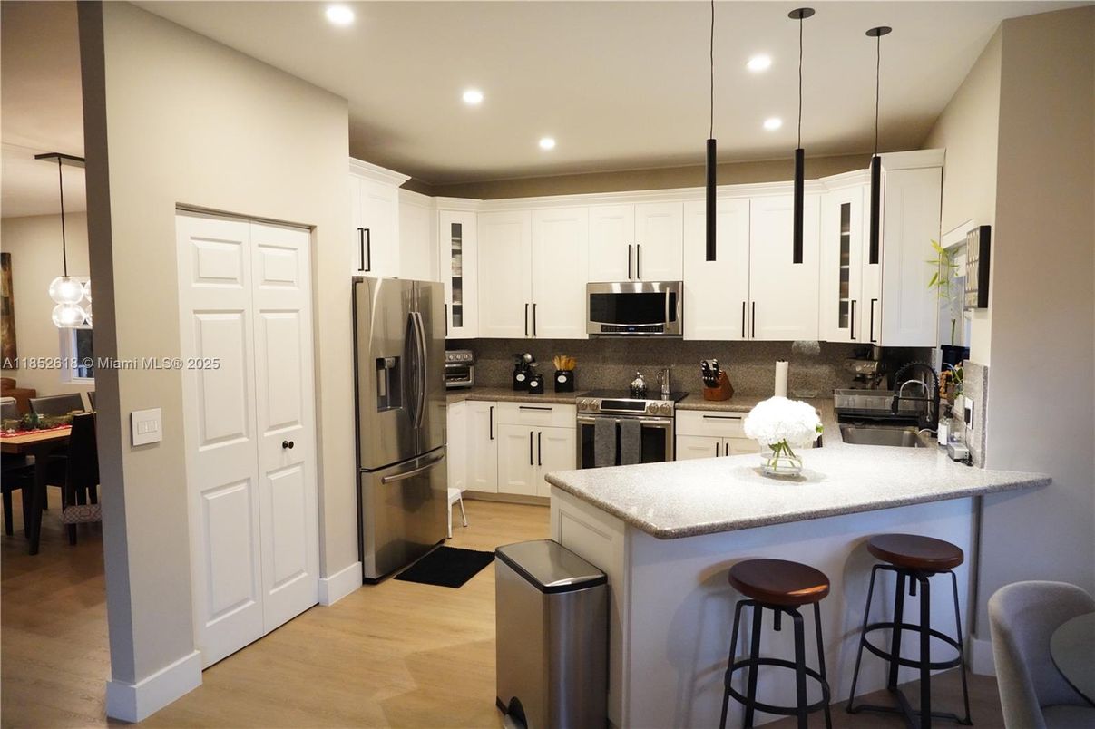 Dining room, Interior, Kitchen, Pendant Lights, Recessed Lighting, Stainless Steel Appliances, Wood Texture Flooring